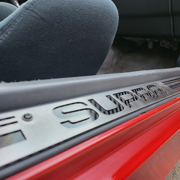 Stainless doorsill with carbon fiber underplate and lines